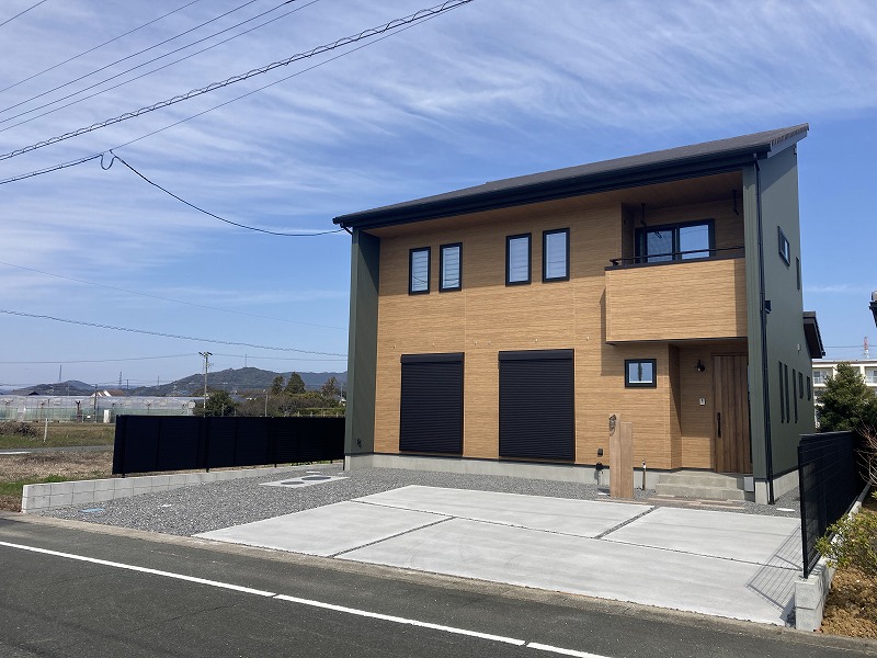 天然木風のコンクリート製枕木材と舗装材、コンクリート舗装以外は防草対策した砕石敷きのシンプルなエクステリア